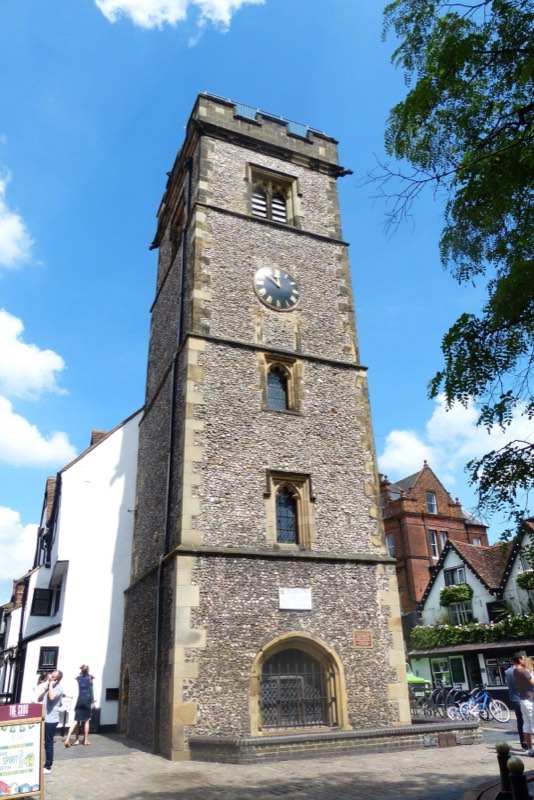 The medieval Clock Tower in St Albans city centre against a blue sky