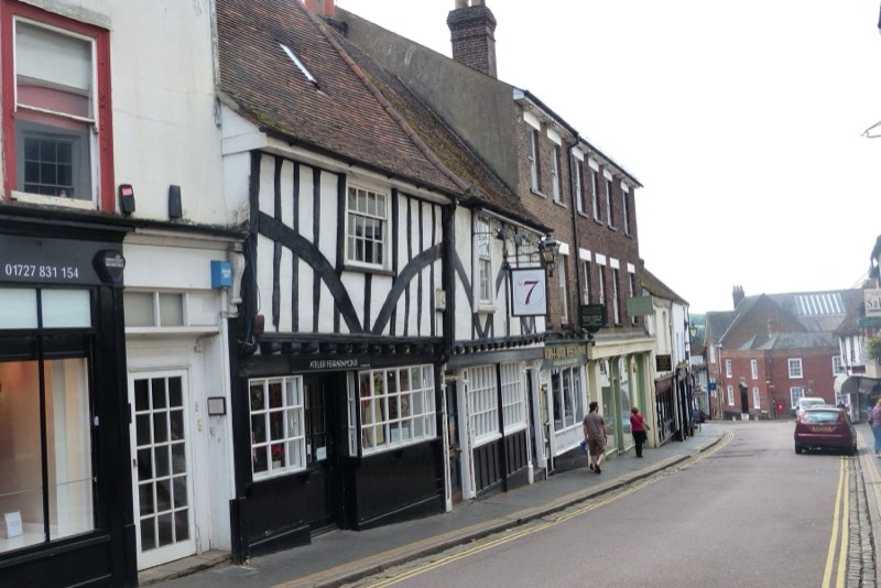 A sloping street of timber-framed and Georgian buildings in the old city