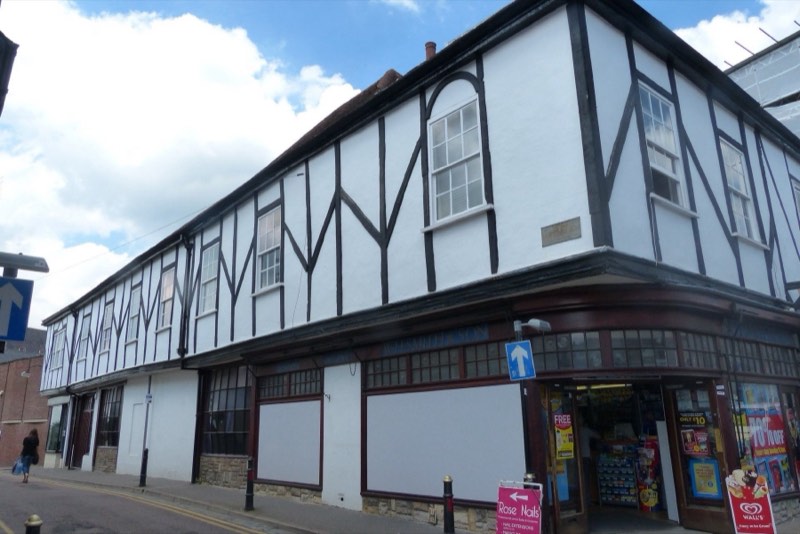 A long timber-framed building on a city centre corner